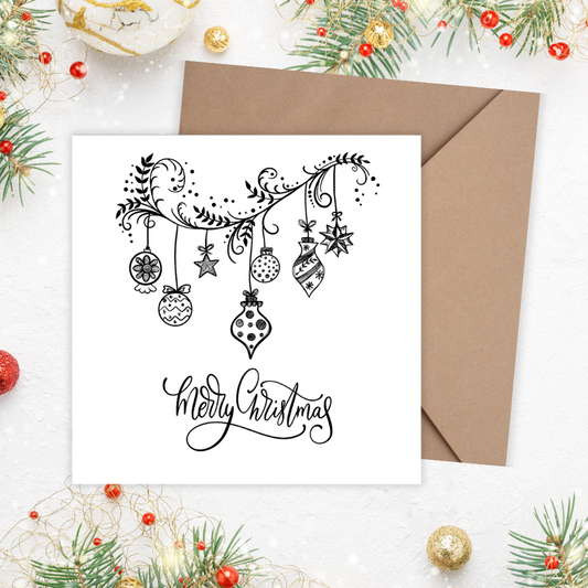 Christmas card with 'Merry Christmas' text and decorations on a white background with a brown envelope.3D Happy Holidays Ornaments Card