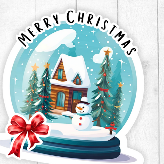 Christmas-themed sticker with a snow globe design featuring a house, trees, and a snowman, with 'Merry Christmas' text above.