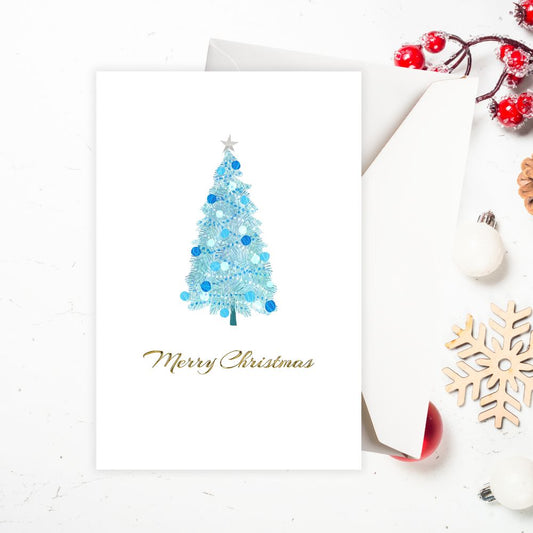 Christmas card with blue tree and 'Merry Christmas' text on a white background. BLUE TREE CHRISTMAS CARD
