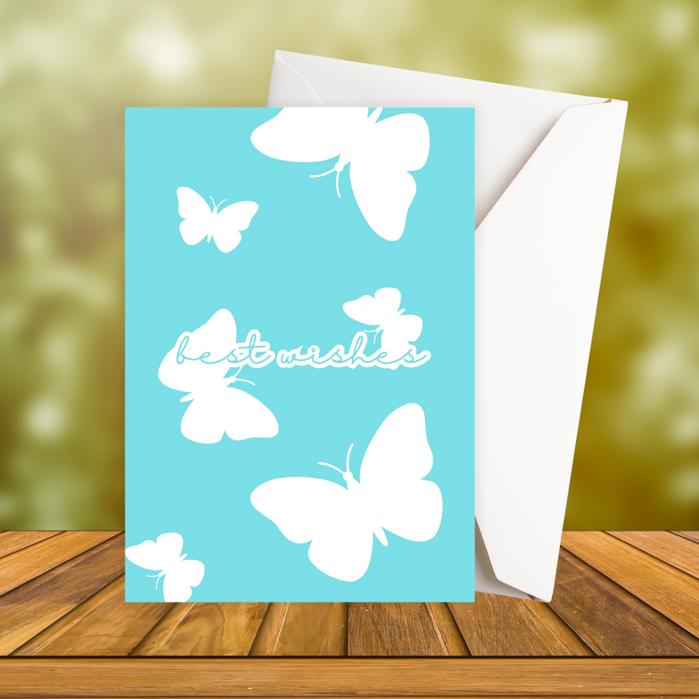 Greeting card with white butterflies and 'best wishes' text on a turquoise background, with a white envelope.