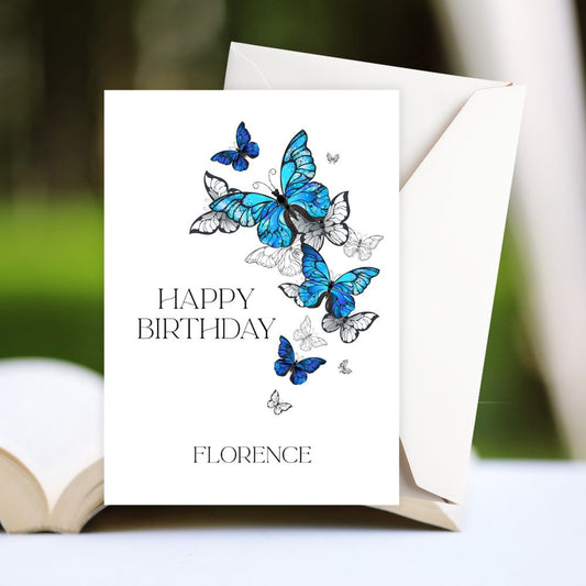Birthday card with blue butterflies and 'Happy Birthday Florence' text on a white background. BLUE BUTTERFLIES PERSONALISED BIRTHDAY CARD