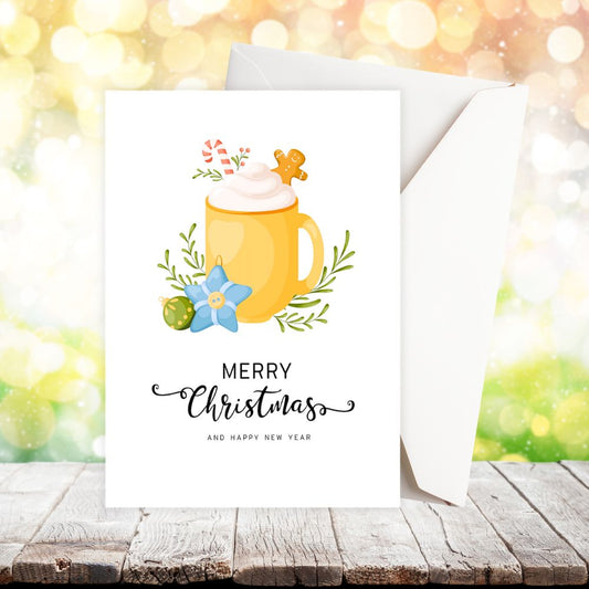 Christmas card with a yellow mug illustration and 'Merry Christmas and Happy New Year' text on a blurred festive background. COCOA CUP CHRISTMAS CARD