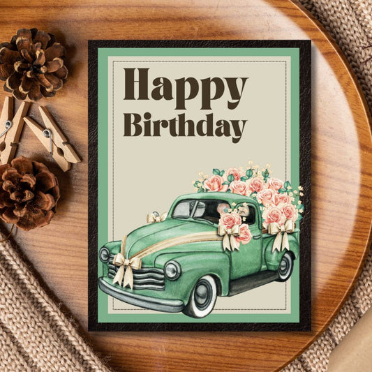 Framed birthday card with a green vintage car and flowers on a wooden surface. Car Vintage Happy Birthday Card