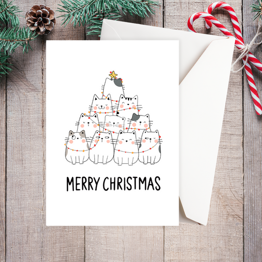 Christmas card with cats and lights design on a wooden surface with festive decorations. Cat Tree Christmas Card