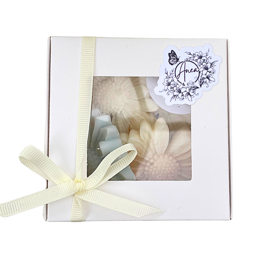 Gift box with a ribbon and a decorative sticker on a white background. DAISY WAX MELTS GIFT BOX