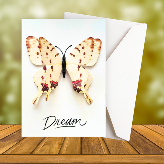 Greeting card with a butterfly design and the word 'Dream' on a wooden surface. Dream 3D Greeting Card.