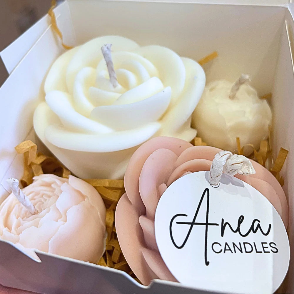 Decorative candles in a box with 'Anea Candles' tag. Christmas Candles