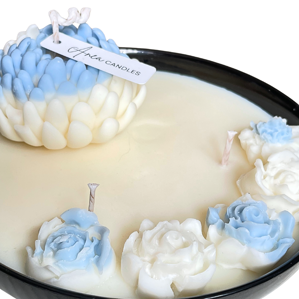 Decorative candle with rose-shaped wax pieces in blue and white, branded 'Aimee Candles'. FLOWER NATURAL SOY CANDLE