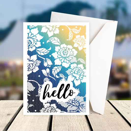 Greeting card with floral design and 'hello' text on a wooden surface with blurred background. Floral pattern Hello Greeting Card
