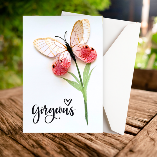 Greeting card with butterfly design and 'gorgeous' text on a wooden surface. Gorgeous 3D Greeting Card