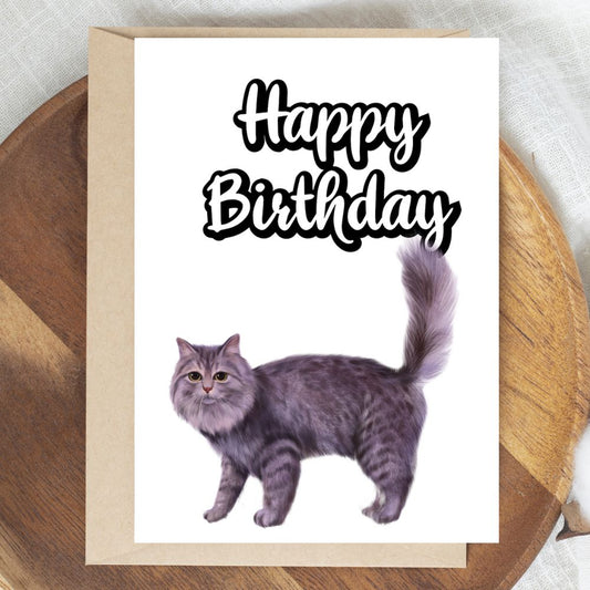 Birthday card with a cat illustration and 'Happy Birthday' text on a wooden surface. Grey Cat Happy Birthday Card