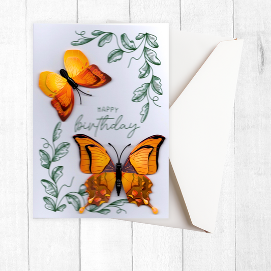 Birthday card with orange butterflies and green leaves on a white background
