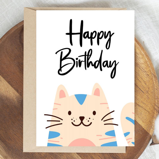 Birthday card with a cat illustration and 'Happy Birthday' text on a wooden surface. Happy Cat Happy Birthday Card
