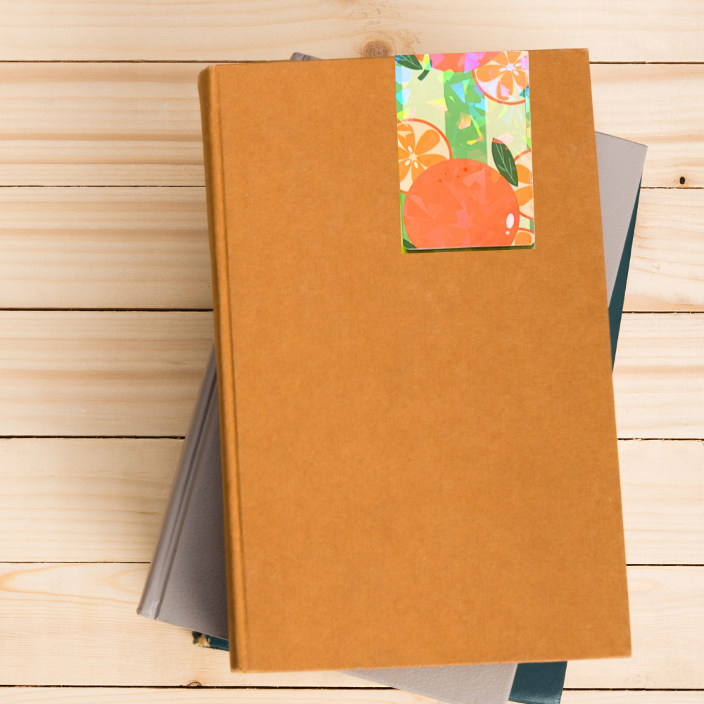 Brown notebook with a colorful fruit-themed label on a wooden surface. Juicy Fruit Bookmark Set