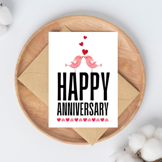 Happy Anniversary card with two birds and hearts on a wooden plate. Kissing Birds Anniversary Card