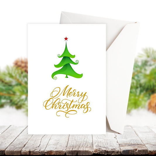 Christmas card with green tree and 'Merry Christmas' text on a wooden surface.LITTLE TREE CHRISTMAS CARD