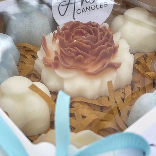 Decorative candles with a rose design in a box labeled 'Candles'. MIX FLOWERS WAX MELTS GIFT BOX 2