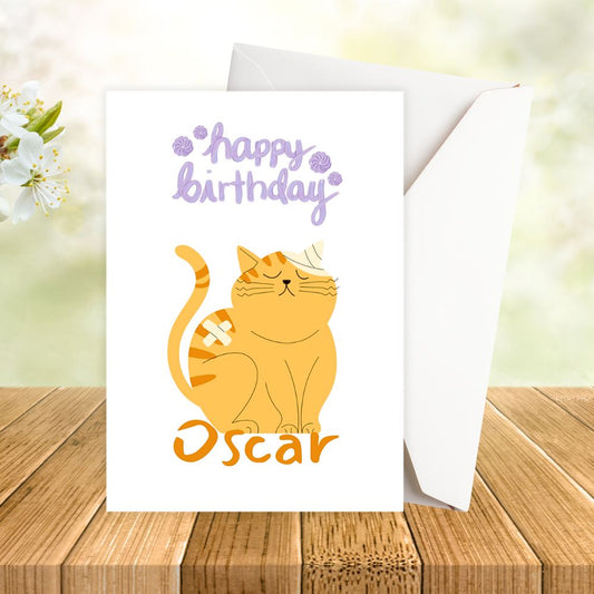 Birthday card with a cat illustration and 'Happy Birthday Oscar' text on a wooden surface. Orange Cat Birthday Personalised Card