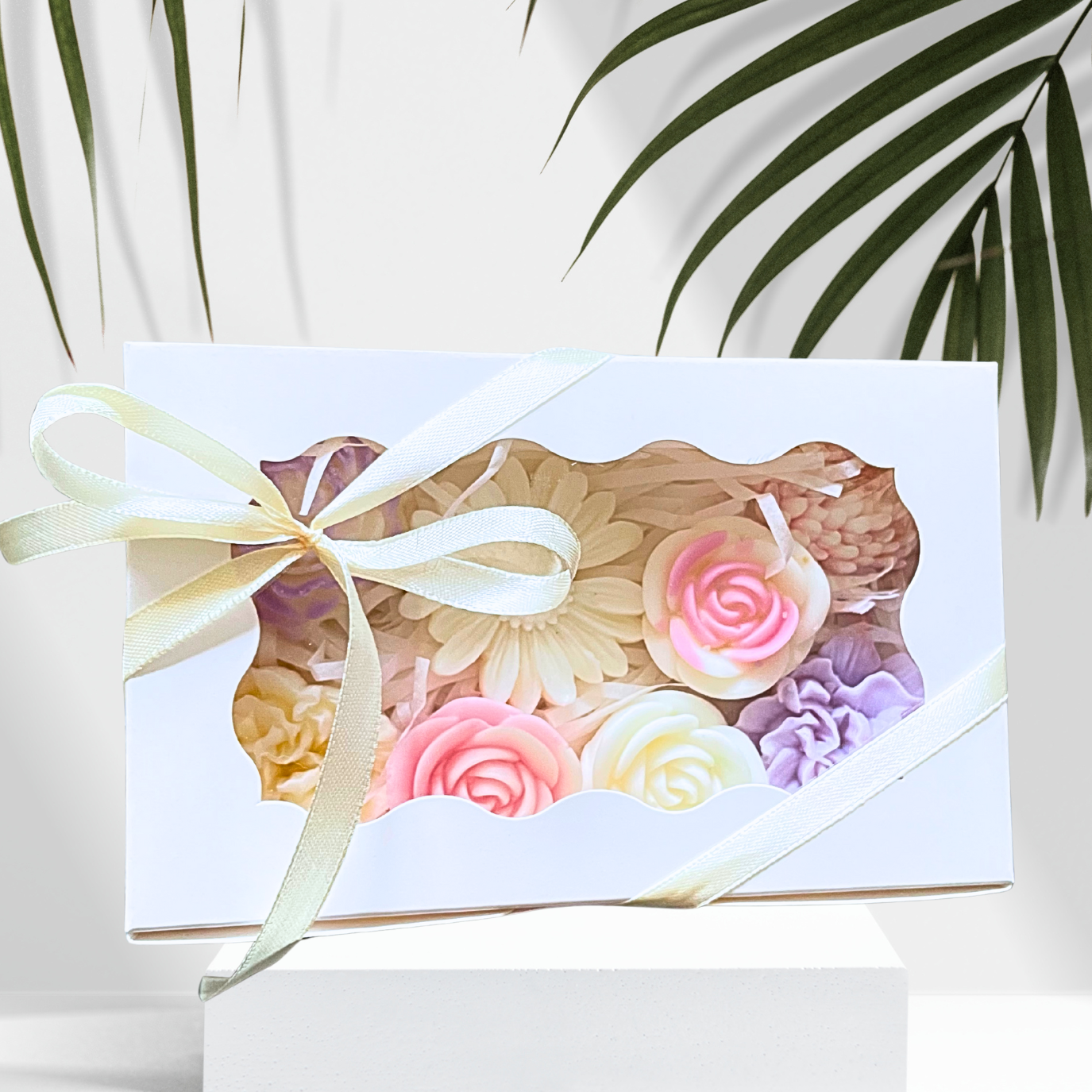 Gift box with floral design and ribbon on a white background with green leaves.PASTEL FLOWERS GARDEN WAX MELTS GIFT BOX
