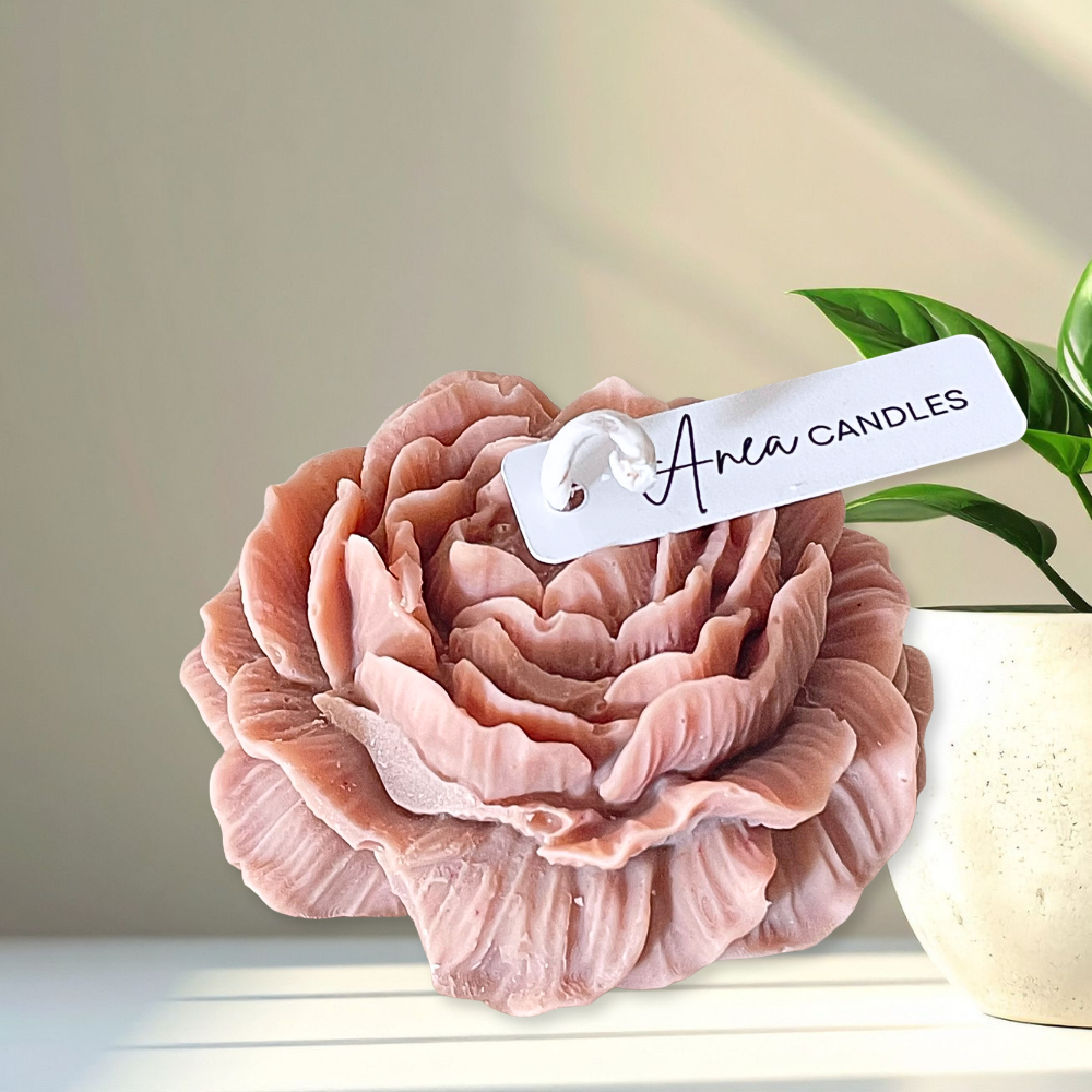 Pink floral candle with 'Aria Candles' tag on a neutral background. PEONY CHRISTMAS SPICE CANDLE