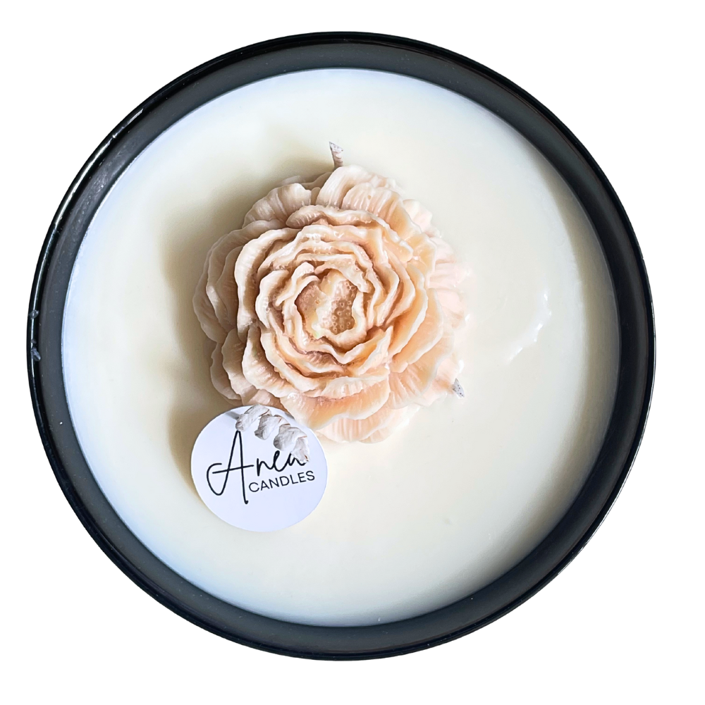 Candle with a rose-shaped candle wick and 'Aven Candles' label on a white background. PEONY FLOWER SOY NTURAL CANDLE