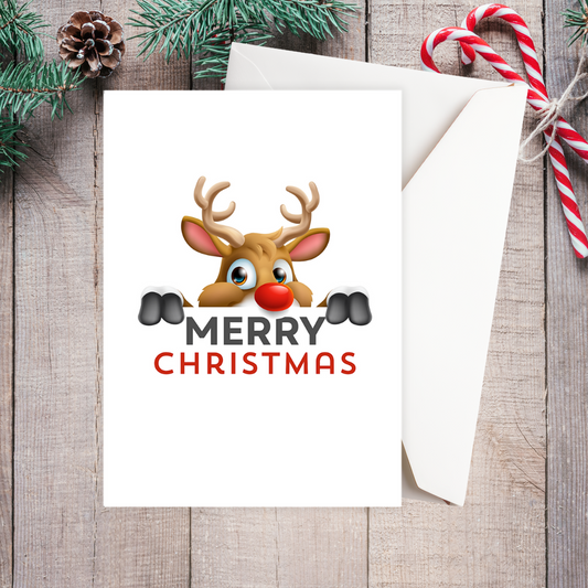Christmas card with a reindeer design and 'Merry Christmas' text on a wooden surface with festive decorations. Peeking Reindeer Christmas Card
