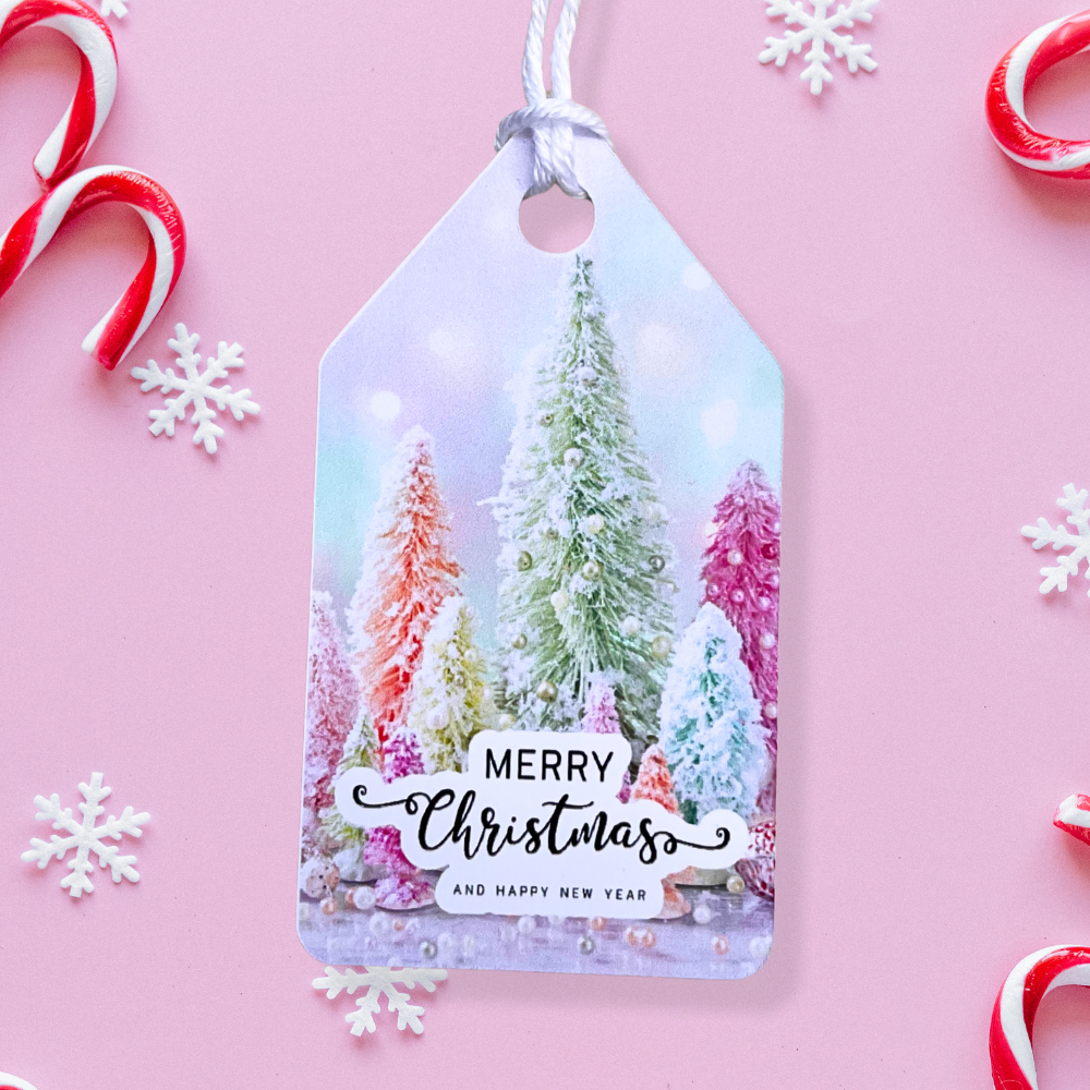 Gift tag with Christmas tree design and 'Merry Christmas and Happy New Year' text on a pink background with candy canes and snowflakes.Pink Christmas Gift Tag Set