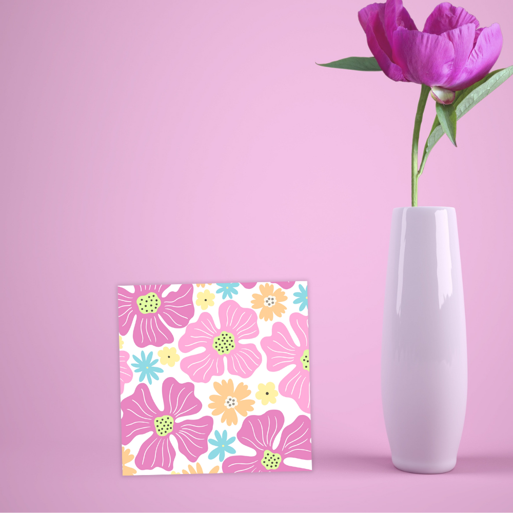 Floral card with pink flowers next to a white vase with a purple tulip on a pink background. Pink Flowers Birthday Card