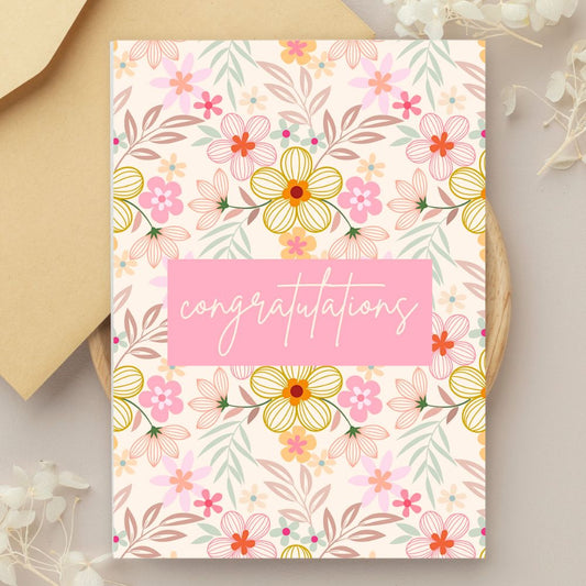Floral congratulation card with 'congratulations' text on a beige background. Pink Wild Flowers Congratulations Card