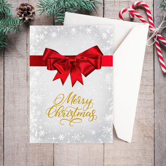 Christmas card with red bow and 'Merry Christmas' text on a wooden surface with candy canes and pine cones.RED RIBBON BOW CHRISTMAS CARD
