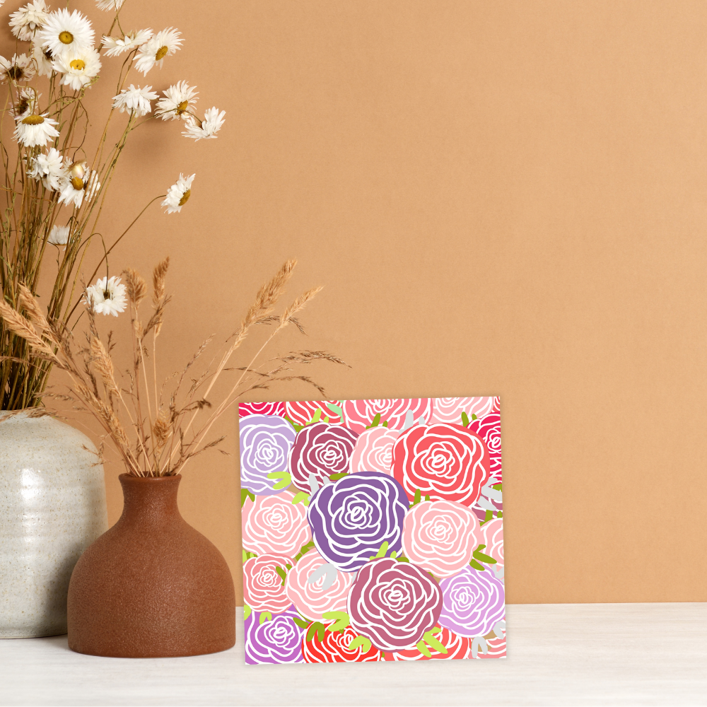 Vase with flowers next to a card with floral pattern on a beige background. Roses Bouquet Birthday Card