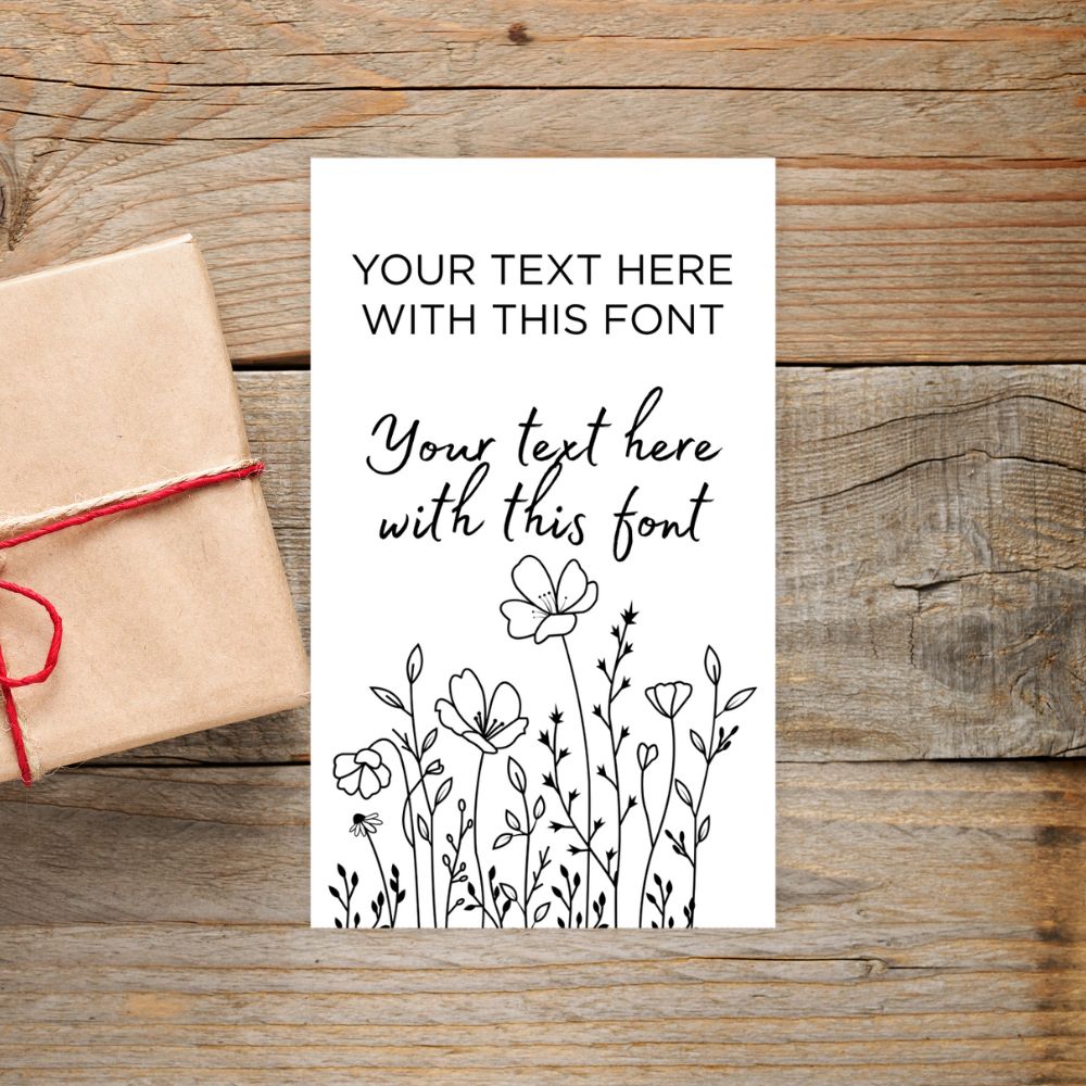 Card with text and floral design on a wooden surface with a gift box.SIMPLE PERSONALISED GIFT TAG