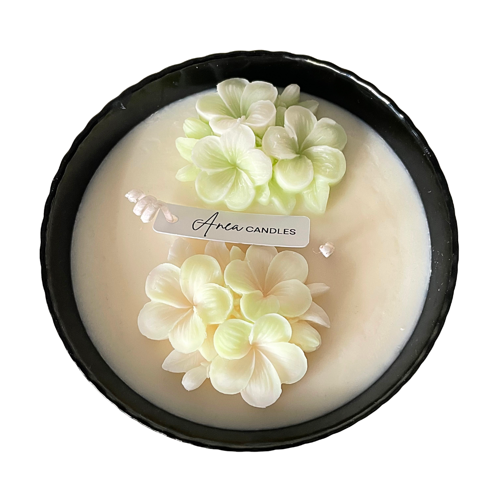 Aveda candle with floral design on a white background. SPRING FLOWER SOY CANDLE