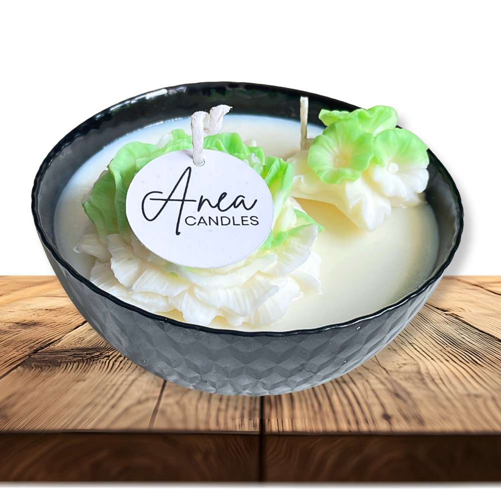 Candle in a decorative bowl with 'Anea Candles' label on a wooden surface. SPRING PEONY SOY CANDLE