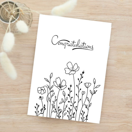 Greeting card with floral design and 'Congratulations' text on a wooden surface. Simple Flowers Congratulations Card