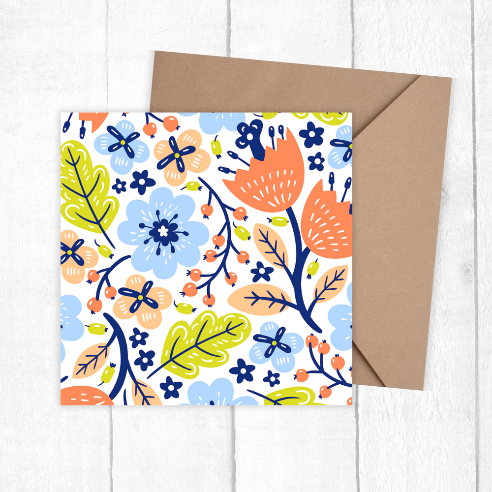 Floral patterned card with a brown envelope on a white wooden surface. Sweet Flowers Pattern Birthday Card