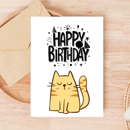 Birthday card with a cat illustration and 'Happy Birthday' text on a wooden surface. Tabby Cat Happy Birthday Card