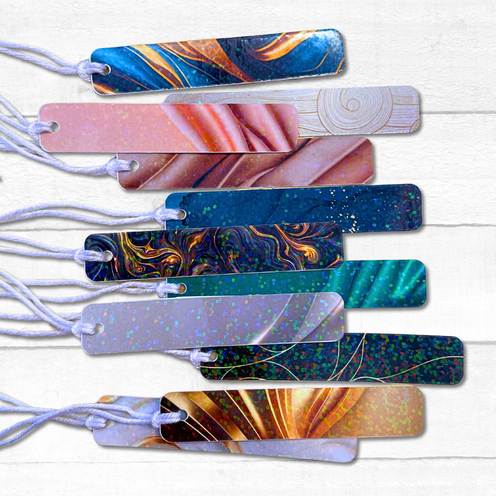 Set of colorful marbled bookmarks on a white wooden surface. VELVET SLIM GIFT TAG SET 1