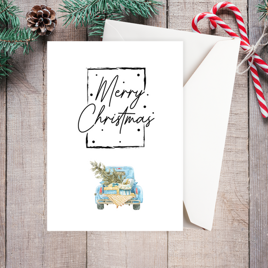 Christmas card with 'Merry Christmas' text and a car illustration on a wooden surface with festive decorations. Vintage Car Christmas Card