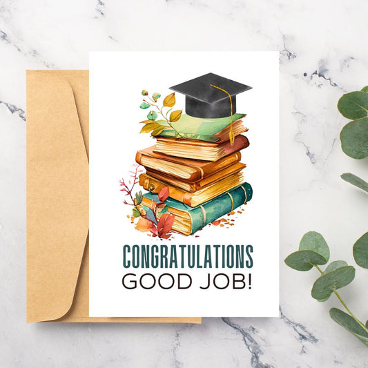 Graduation-themed card with books, mortarboard, and 'Congratulations Good Job!' text on a marble surface.Vintage Congratulations Graduation Card