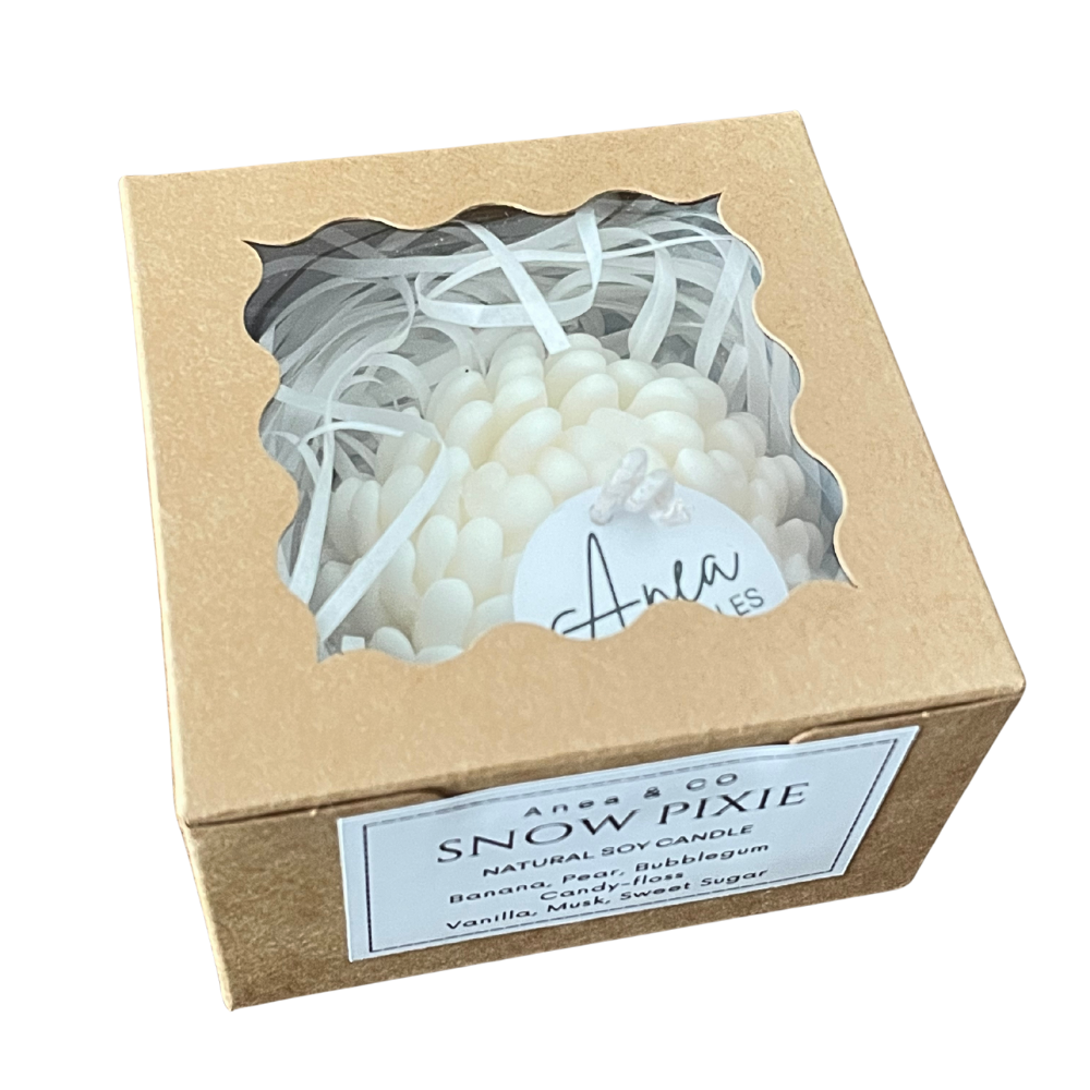Snow pixie candle in a cardboard box with 'Anes & Co' branding. PEONY SNOW PIXIE SOY CANDLE