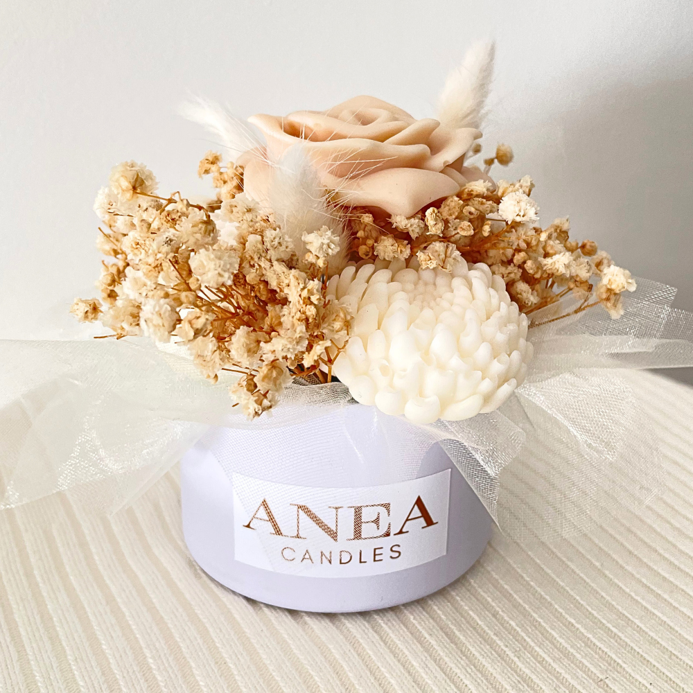 Decorative candle with flowers and 'ANEA CANDLES' label on a neutral background. CREAM WAX MELT FLOWER MINI BOUQUET