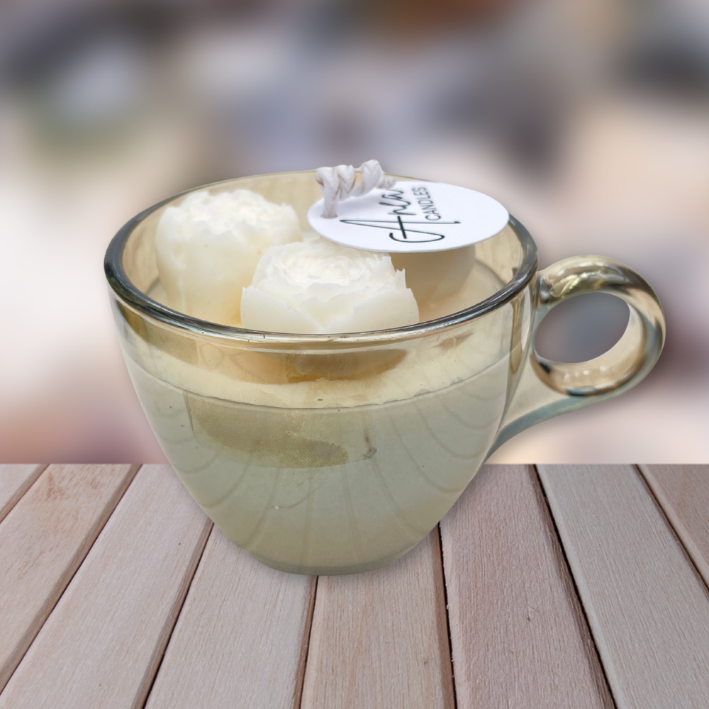 Glass mug with two white固体 on a wooden surface. CHOCOLATE FRESH LINEN CANDLE II