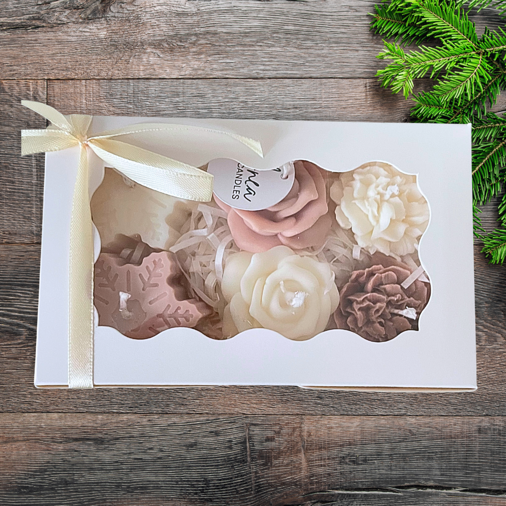 Set of floral candles in a decorative box on a wooden surface with greenery.CHRISTMAS SPICE MIXED CANDLE GIFT BOX
