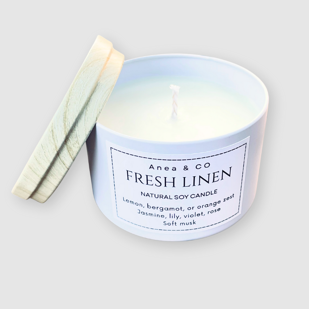 Candle labeled 'Fresh Linen' by Anea & Co on a light gray background. fresh linen natural soy candle