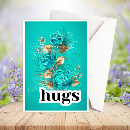 Greeting card with teal roses and the word 'hugs' on a wooden surface with flowers in the background