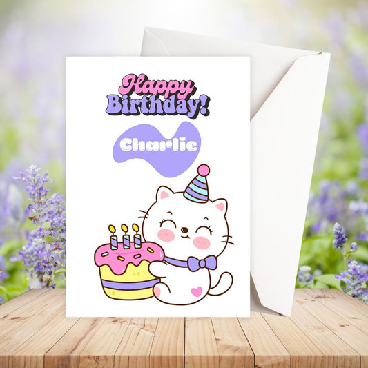 Birthday card with a cartoon cat holding a cake and the text 'Happy Birthday Charlie' on a wooden surface with flowers in the background. Cake Cat Birthday Personalised Card