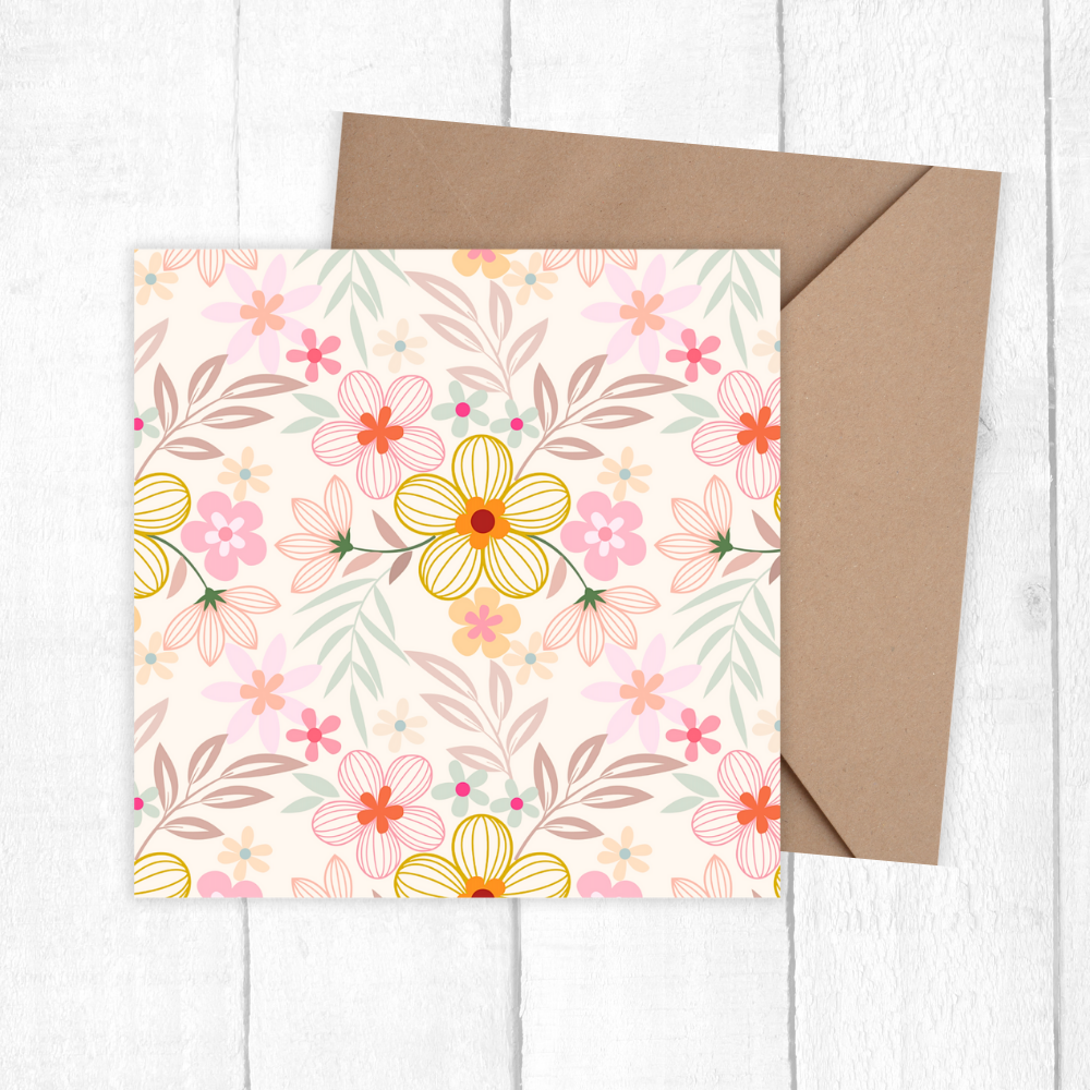 Floral card with a brown envelope on a white wooden surface. pastel Flowers Birthday Card
