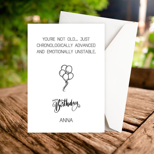 Birthday card with humorous message on a wooden surface. you are not old personalised rude birthday card