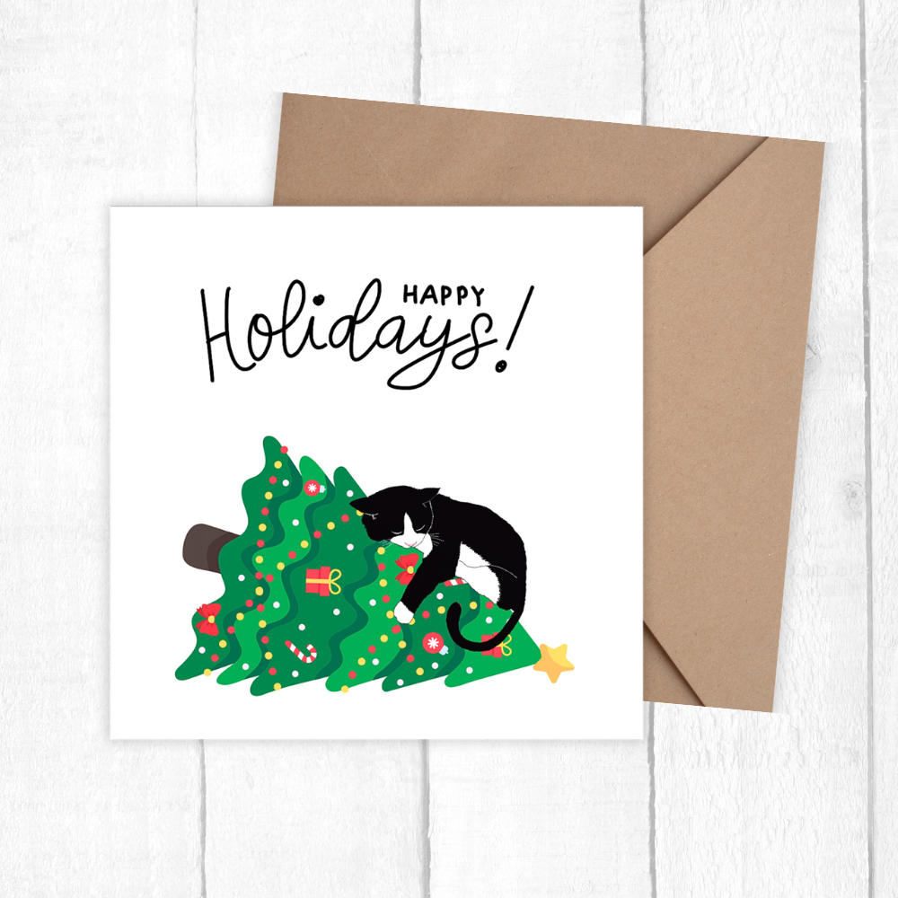 Greeting card with a cat on a Christmas tree and 'Happy Holidays!' text, accompanied by a brown envelope.3D Cat on the Tree Christmas Card